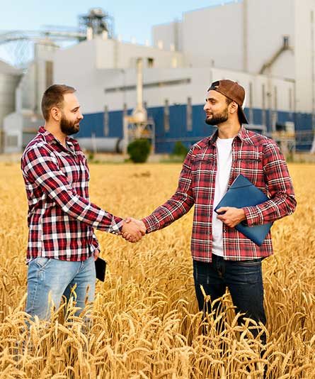 two men in grain field 